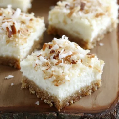 Skinny Coconut Cheesecake Bars topped with shredded coconut
