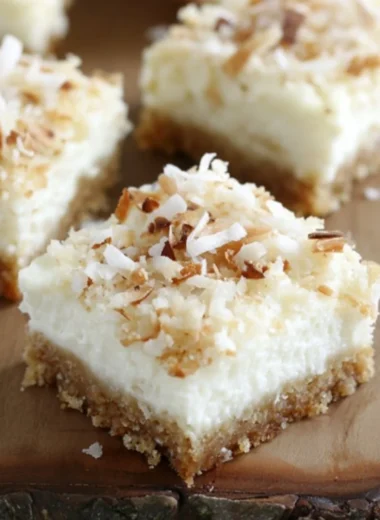 Skinny Coconut Cheesecake Bars topped with shredded coconut