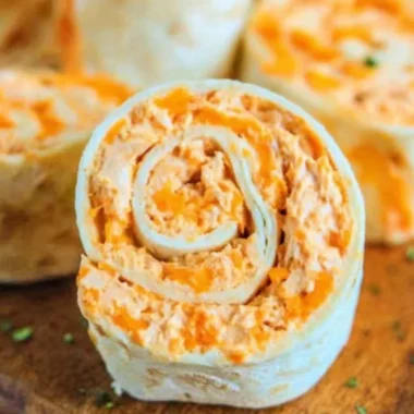 Buffalo Chicken Roll Ups served on a plate with dipping sauce