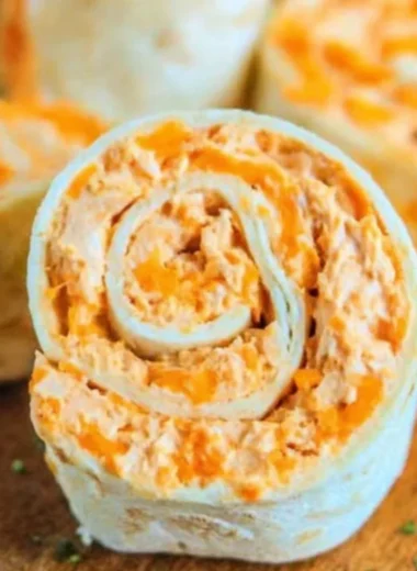Buffalo Chicken Roll Ups served on a plate with dipping sauce