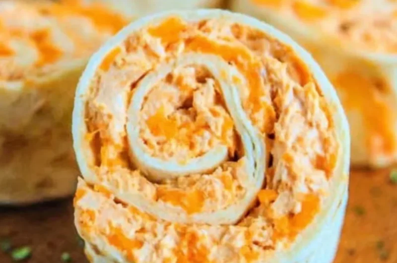 Buffalo Chicken Roll Ups served on a plate with dipping sauce