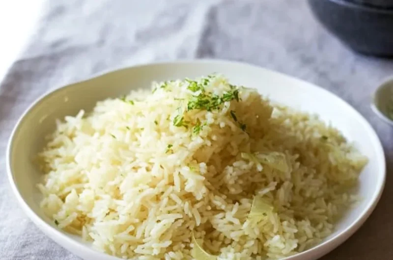 Creamy butter rice served in a bowl with herbs and spices
