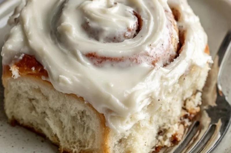 Freshly baked cinnamon rolls with a swirl of cinnamon and icing