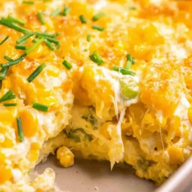 Cream Cheese Corn Casserole topped with golden cheese and herbs