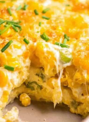 Cream Cheese Corn Casserole topped with golden cheese and herbs