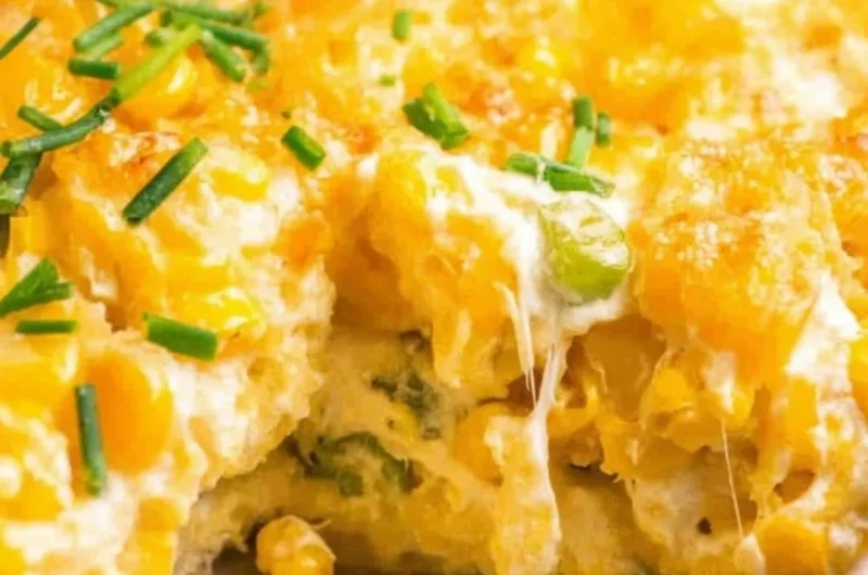 Cream Cheese Corn Casserole topped with golden cheese and herbs