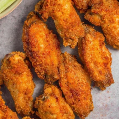Crispy air fryer chicken wings served on a plate with dipping sauce