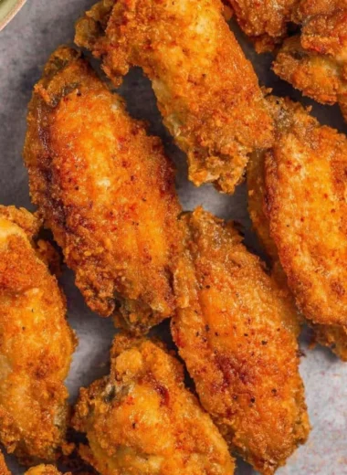 Crispy air fryer chicken wings served on a plate with dipping sauce