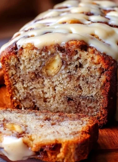 Loaf of easy cinnamon roll banana bread with cinnamon glaze