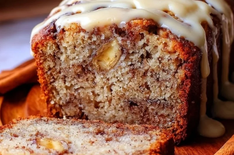 Loaf of easy cinnamon roll banana bread with cinnamon glaze