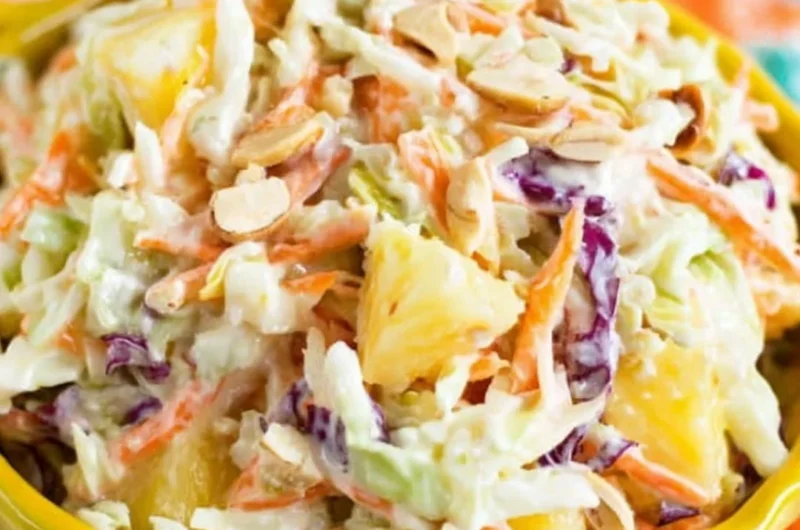 Bowl of Hawaiian coleslaw with pineapple and colorful veggies