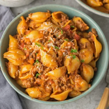 High protein taco pasta with colorful ingredients in a bowl