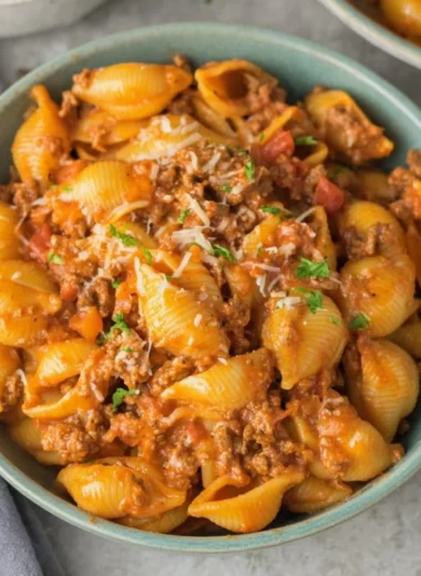 High protein taco pasta with colorful ingredients in a bowl