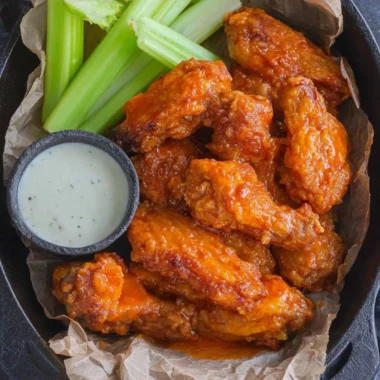 Plate of homemade buffalo wings served with celery and blue cheese dressing