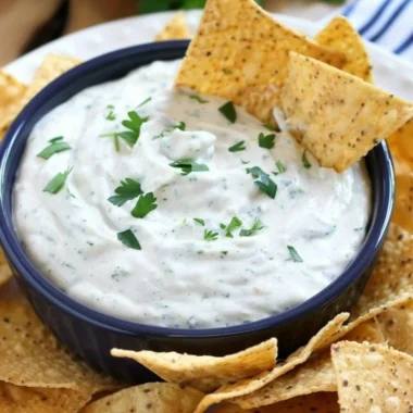 Bowl of homemade ranch dip with fresh vegetables and crackers