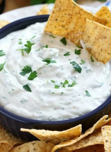 Bowl of homemade ranch dip with fresh vegetables and crackers