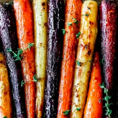 Plate of honey roasted colorful carrots garnished with herbs