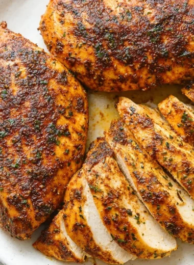 Juicy baked chicken breast served with vegetables on a plate