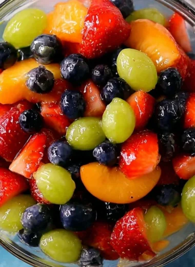Delicious quiche served with colorful fruit salad and shrimp and grits.