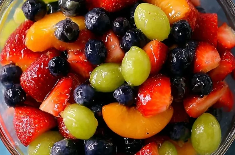 Delicious quiche served with colorful fruit salad and shrimp and grits.