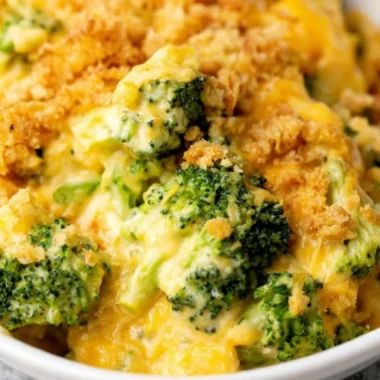 Velveeta broccoli casserole dish served on a table with a side salad