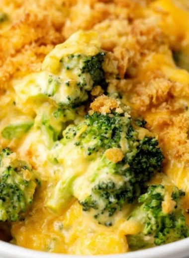 Velveeta broccoli casserole dish served on a table with a side salad