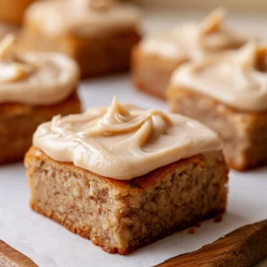 Delicious banana bread brownies served on a plate, garnished with nuts.