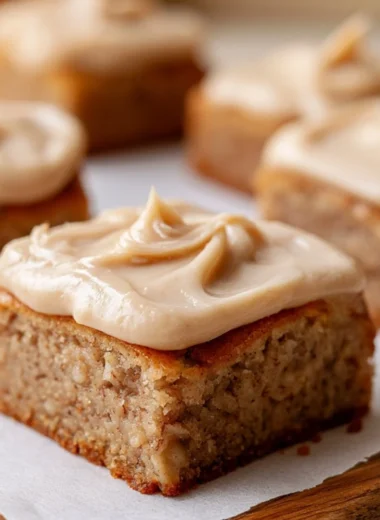 Delicious banana bread brownies served on a plate, garnished with nuts.