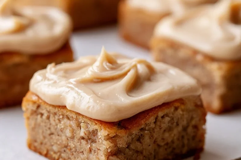 Delicious banana bread brownies served on a plate, garnished with nuts.