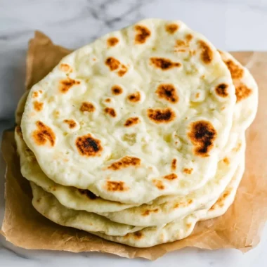 Delicious homemade Greek pita bread on a wooden table