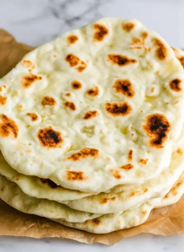 Delicious homemade Greek pita bread on a wooden table