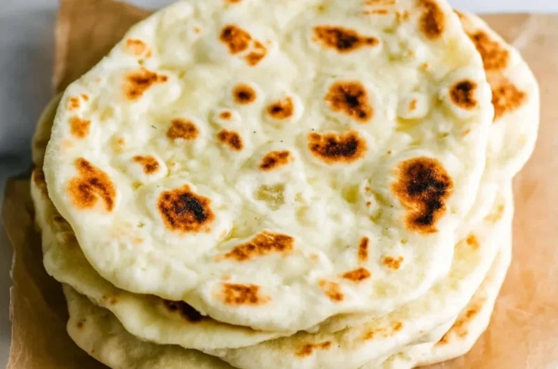 Delicious homemade Greek pita bread on a wooden table
