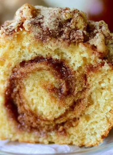 Delicious Cinnamon Swirl Coffee Cake served on a rustic wooden table.