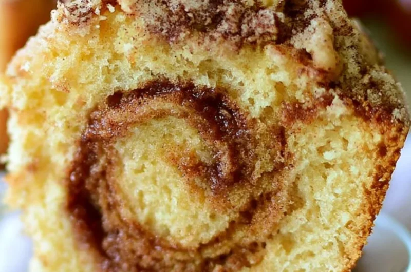 Delicious Cinnamon Swirl Coffee Cake served on a rustic wooden table.