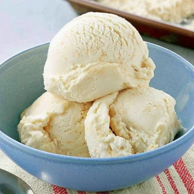 Delicious homemade cake batter ice cream in a bowl with sprinkles.