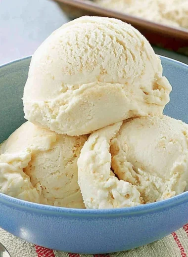 Delicious homemade cake batter ice cream in a bowl with sprinkles.