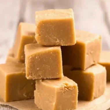 Delicious easy peanut butter fudge in a square dish, showcasing a rich texture.