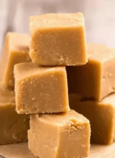 Delicious easy peanut butter fudge in a square dish, showcasing a rich texture.