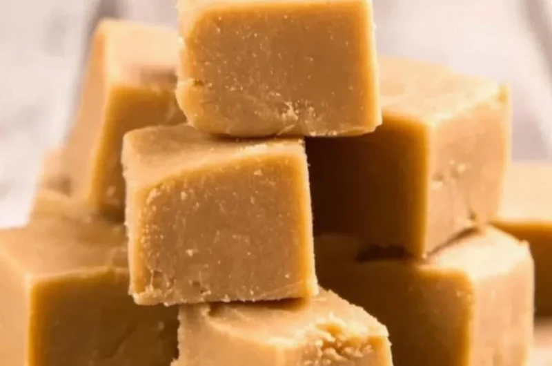 Delicious easy peanut butter fudge in a square dish, showcasing a rich texture.
