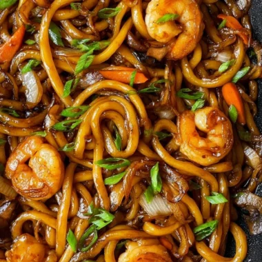 Delicious plate of fried udon noodles with vegetables and sauce
