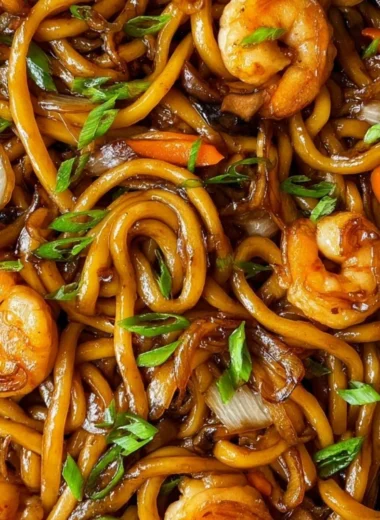 Delicious plate of fried udon noodles with vegetables and sauce