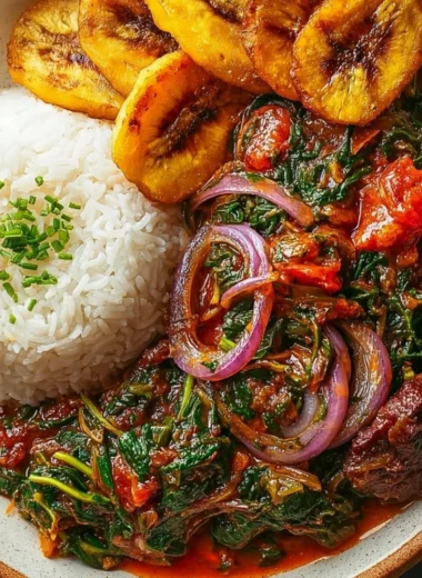 Bowl of Ghanaian Spinach Stew topped with vegetables and spices
