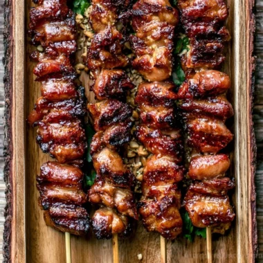 Grilled Thai Coconut Chicken skewers garnished with herbs