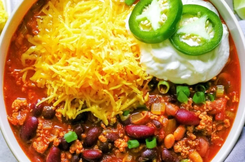 Bowl of healthy turkey chili topped with avocado and cilantro