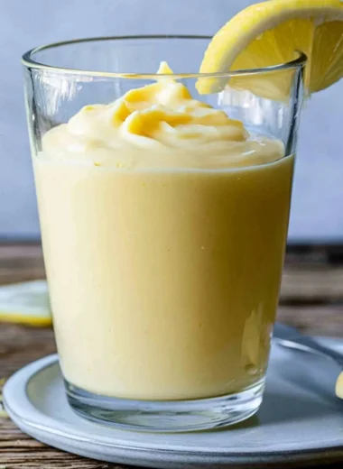 Delicious lemon cream dessert in a bowl with lemon slices