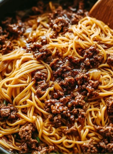Delicious plate of Mongolian ground beef noodles with vegetables and spices.