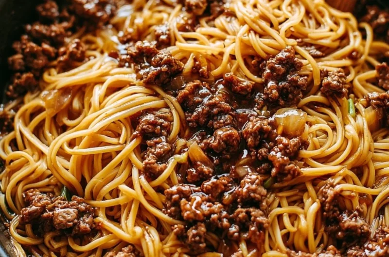 Delicious plate of Mongolian ground beef noodles with vegetables and spices.