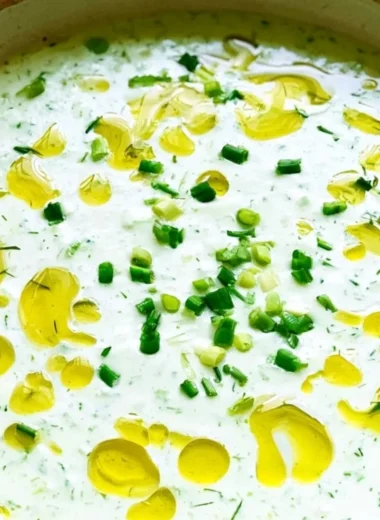 Chilled cucumber gazpacho served in a bowl, garnished with fresh herbs.