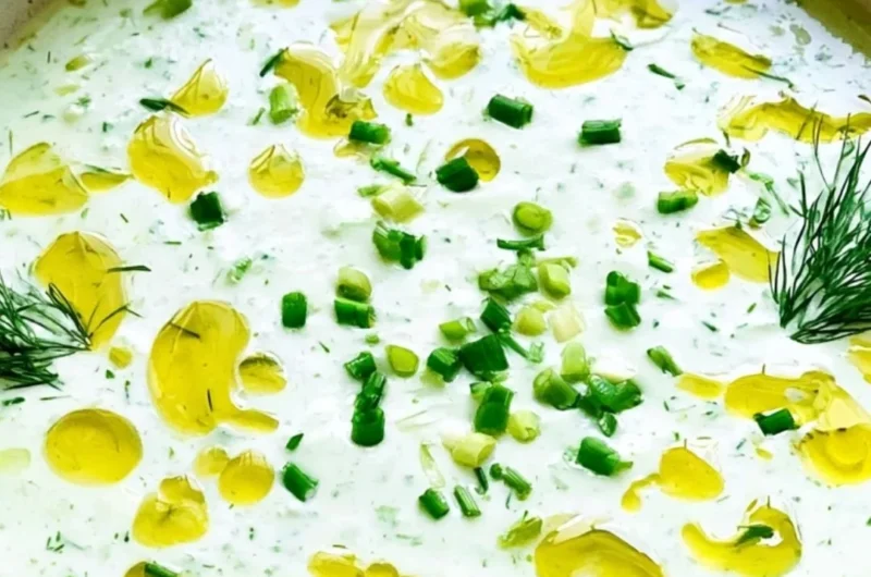 Chilled cucumber gazpacho served in a bowl, garnished with fresh herbs.