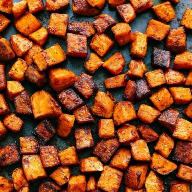 Bowl of colorful roasted vegetables, showcasing vibrant peppers, carrots, and zucchini.